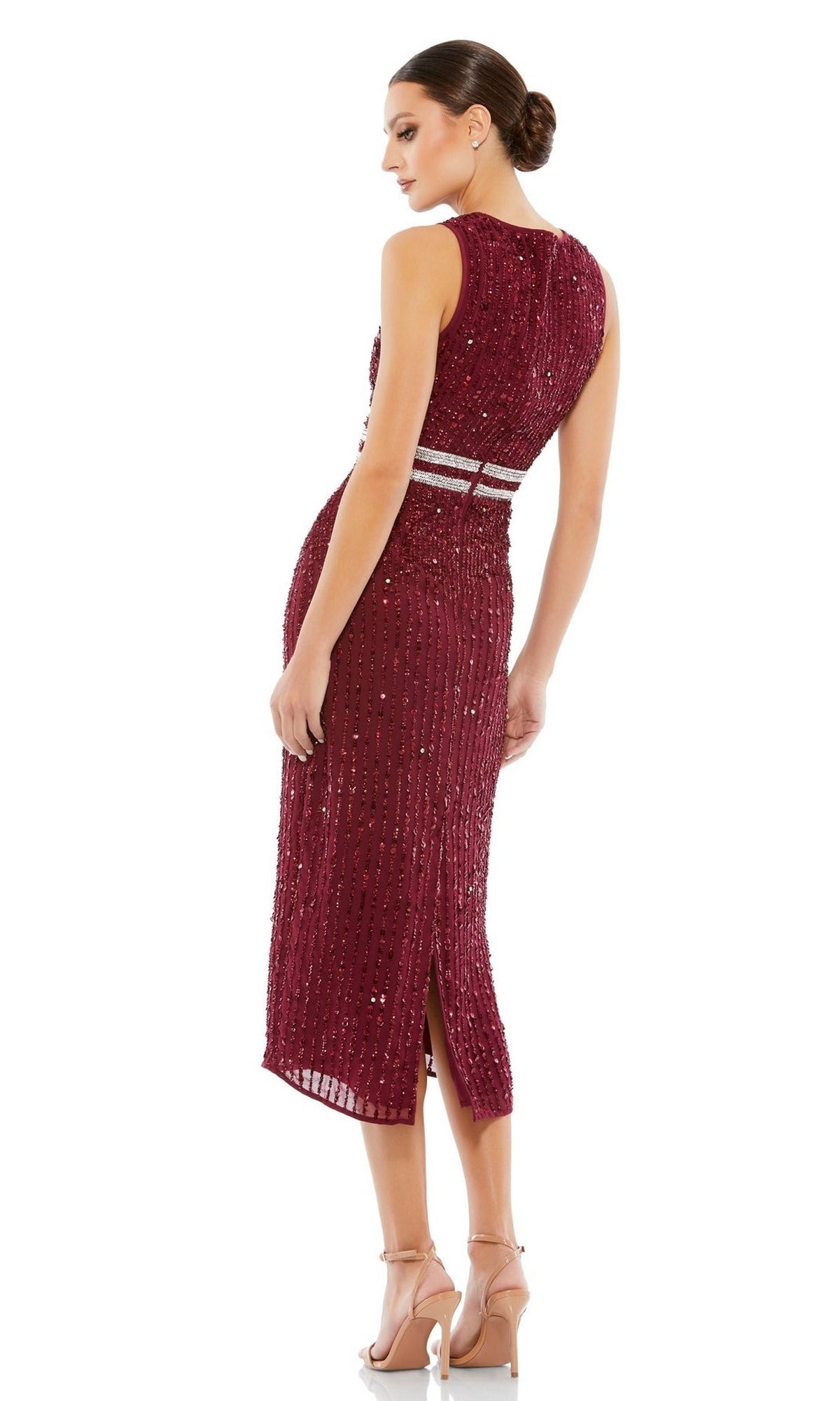 Woman in profile wears the Mac Duggal 10509: a sleeveless, burgundy sequin wedding guest dress with silver waistband accents and back slit; styled with a low bun and neutral heels.